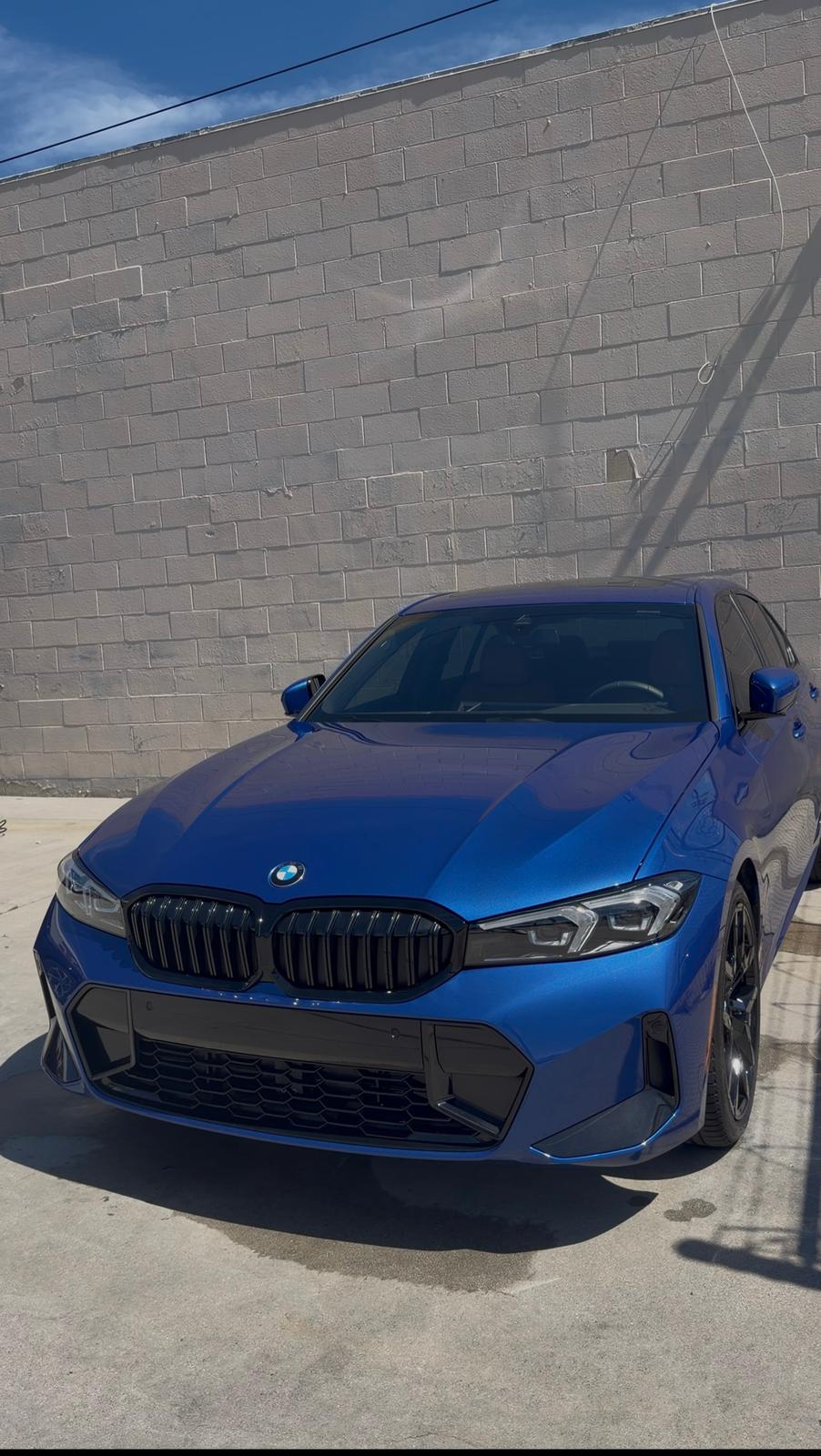 Exterior car detail on a blue BMW with a glossy finish